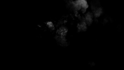 Wall Mural - a small, turbulent cloud of white smoke materializes and drifts on a black background. magical puff 