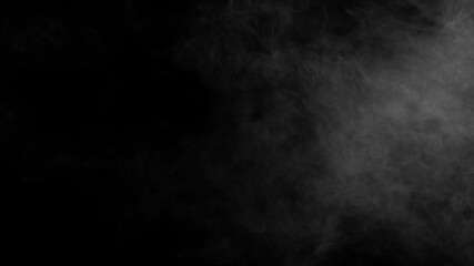 Wall Mural - thick white fog or smoke spreads slowly from the right across a black background. ideal for atmosphe