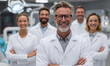 © Milon - A group of smiling dentists in white coats standing in a dental office setting