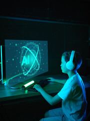 Boy interacts with holographic AI interface on a curved monitor in a dark, neon, high-tech setting. Concept of futuristic education, virtual environments and human-computer interaction
