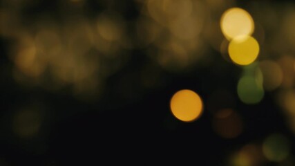 Wall Mural - Mesmerizing shimmering yellow golden bokeh lights create a magical festive atmosphere. Loop animation, seamless, endless footage.