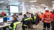 © N7 - Blurred emergency operations center with rescue team gathered for quick response briefing