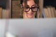 © simona - Professional young woman working in modern office with laptop and desktop computer – focused business environment, digital work, smart working and technology concept