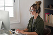 © simona - Professional young woman working in modern office with laptop and desktop computer – focused business environment, digital work, smart working and technology concept