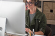 © simona - Professional young woman working in modern office with laptop and desktop computer – focused business environment, digital work, smart working and technology concept