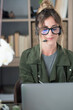 © simona - Professional young woman working in modern office with laptop and desktop computer – focused business environment, digital work, smart working and technology concept