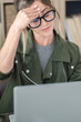 © simona - Professional young woman working in modern office with laptop and desktop computer – focused business environment, digital work, smart working and technology concept