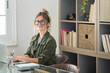 © simona - Professional young woman working in modern office with laptop and desktop computer – focused business environment, digital work, smart working and technology concept