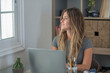 © simona - Professional young woman working in modern office with laptop and desktop computer – focused business environment, digital work, smart working and technology concept