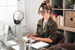 © simona - Young woman working remotely from home office with laptop – freelance job, smart working and digital lifestyle for modern business, remote work and independent career concept