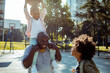 © Davor - Family playing basketball together on outdoor court
