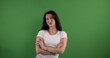 © 4kclips - Young woman crossing her arms with a confident expression on green screen background
