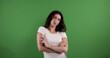 © 4kclips - Young woman crossing arms showing confidence on green screen background