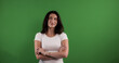 © 4kclips - Studio portrait of a young woman smiling and thinking with arms crossed against a chroma key background