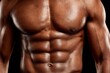 © Narongsag - Close up of a fit Black male torso with defined abdominal muscles and visible sweat