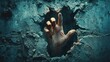 © MBRAMO - Ghastly hand emerging from cracked wall