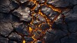 © NKCoolper - Close up of a rugged volcanic rock surface with intense glowing orange lava fissures running through the charred cracked texture