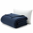 © ศาศวัต ธีรเศรษฐบดี - Soft, plush navy blue blanket neatly folded beside a crisp white pillow, ideal for cozy bedding or home comfort setups.