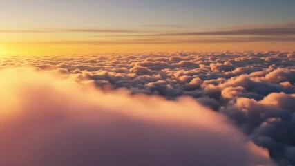 Aerial view of a sea of clouds illuminated by the golden light of the setting or rising sun above the horizon