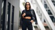 © Kishan - Woman in black leather jacket and sunglasses.