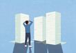© fStop - Overwhelmed man with hands on head looking at large stacks of paperwork