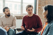 © Maria Vitkovska - Handsome man sharing ideas during support group meeting