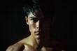 © JEMEE - Close-up image of young man with dark hair staring at the camera with neutral expression