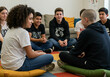 © Arteis - A diverse group of teenagers seated in a circle, engaged in conversation and discussion.