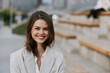 © SHOTPRIME STUDIO - smiling woman in business jacket outdoors urban background confident emotion autumn season