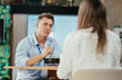 © Suteren Studio - Young businessman eating healthy salad lunch with colleagues in modern office cafeteria