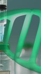 Wall Mural - animation of dna strand over vials and syringe on white background