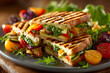 © john - Delicious grilled vegetable panini with cheese and pesto, served with fresh salad and fruit