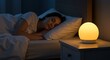 © Meiza - Woman peacefully asleep in her bed illuminated by a bedside lamp