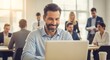 © Axelia - Smiling Businessman Using Laptop at Bright Office Meeting Table