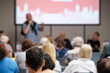 © Anton Gvozdikov - Audience in conference room attentively listens to professional presentation with speaker and stage.