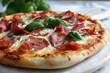 © Jill Dundee - Delicious freshly baked pizza topped with sliced meats and fresh basil on a wooden board