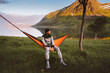 © EVERST - Man chilling in hammock traveling solo in Norway outdoor camping gear summer vacations traveler enjoying mountain and fjord view eco tourism adventure healthy lifestyle trip weekend in the wild