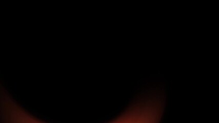 Wall Mural - Abstract illustration of a dark background with a subtle, blurred reddish-orange glow emanating