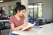 © Fahng - Relaxed young student woman reading a book in university campus.