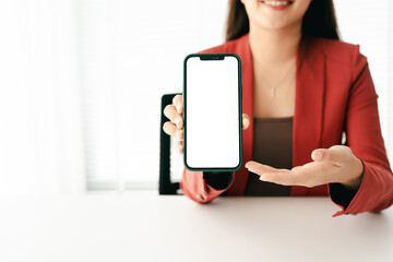 Wall Mural - close-up of young woman holding blank screen smartphone, typing text, chatting with friends on socia