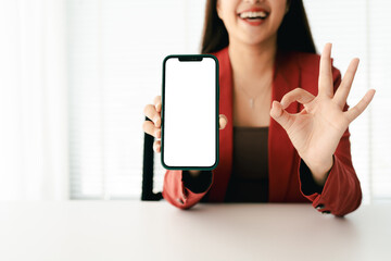 Wall Mural - close-up of young woman holding blank screen smartphone, typing text, chatting with friends on socia