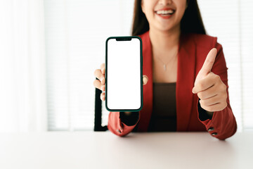 Wall Mural - close-up of young woman holding blank screen smartphone, typing text, chatting with friends on socia
