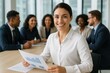 © Thitiporn - Poised Leader: A composed business leader, with a genuine smile, confidently reviews a business chart amidst a supportive, multicultural team. The image radiates professionalism and optimism.