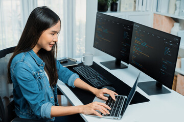 Wall Mural - smiling young asian in it developer creating with typing online information on laptop with coding pr