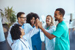 © Dragana Gordic - Medical Team Celebrating Success With a Cheerful High Five Gesture