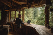 © s1llu - Person Working on Laptop in Rustic Cabin