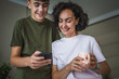 © Miljan Živković - mother and young son teenage boy use mobile phone together at home