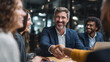 © Techno Stoks - Businessman shaking hands with colleague after meeting in office. Group of multiracial business partners shaking hands in coworking office space