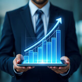 Businessman shows financial growth graph on a tablet, symbolizing market success and profit