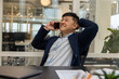 © zinkevych - Young manager talking on the phone and feeling joyful and contented